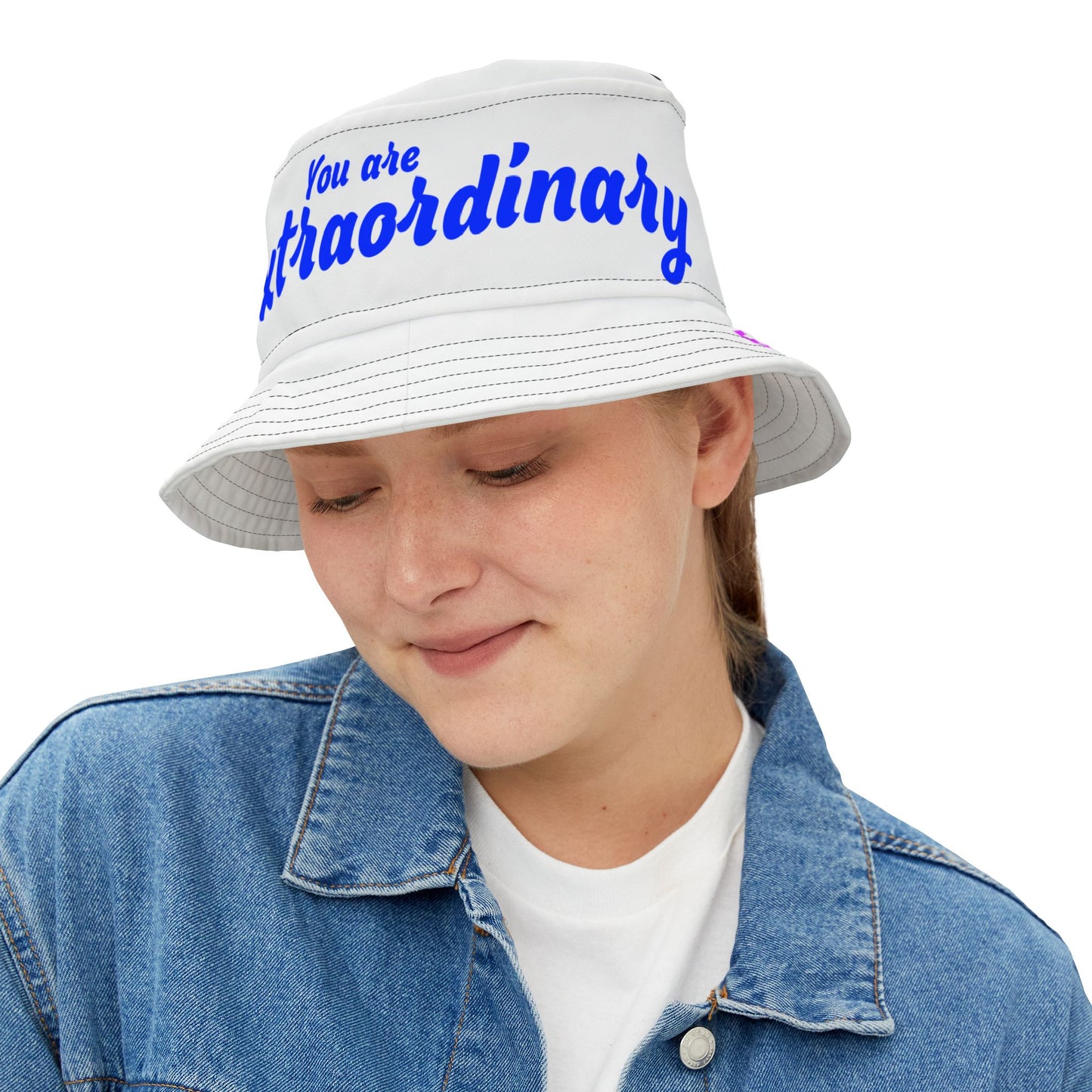 Person wearing a white bucket hat with blue text on a white background