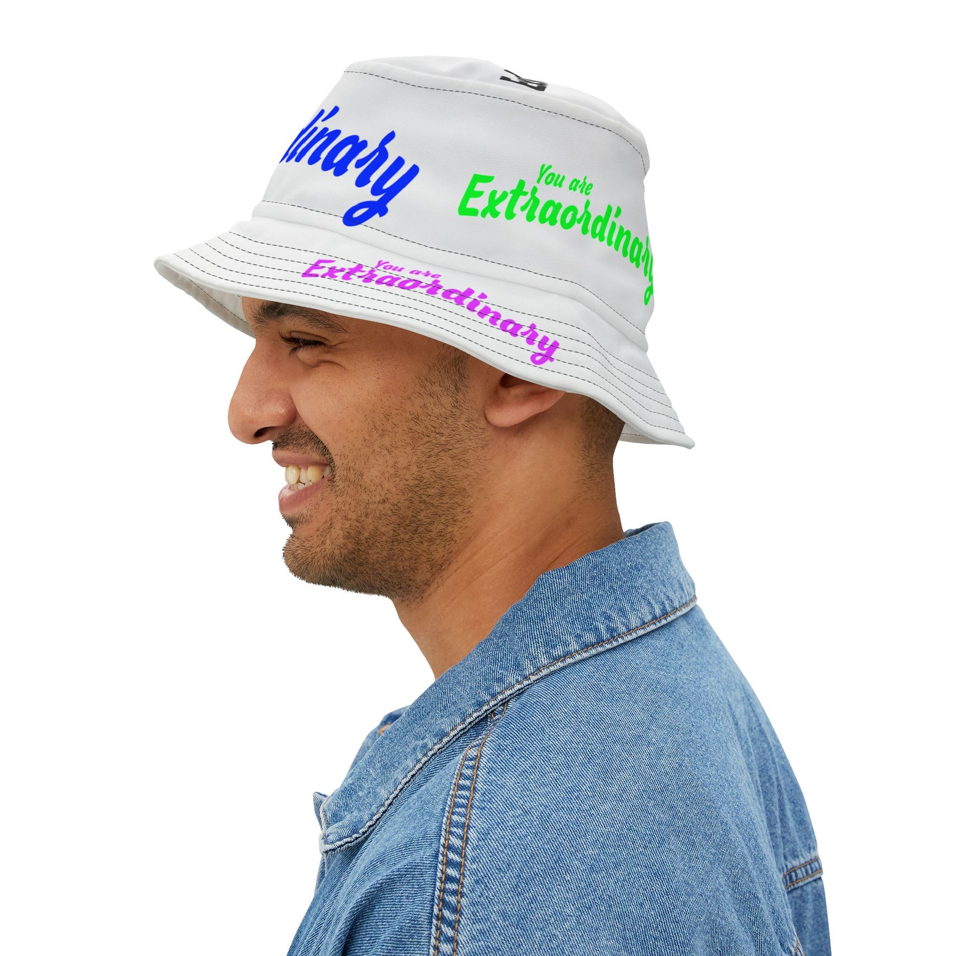Man wearing a white bucket hat with text, smiling on a white background